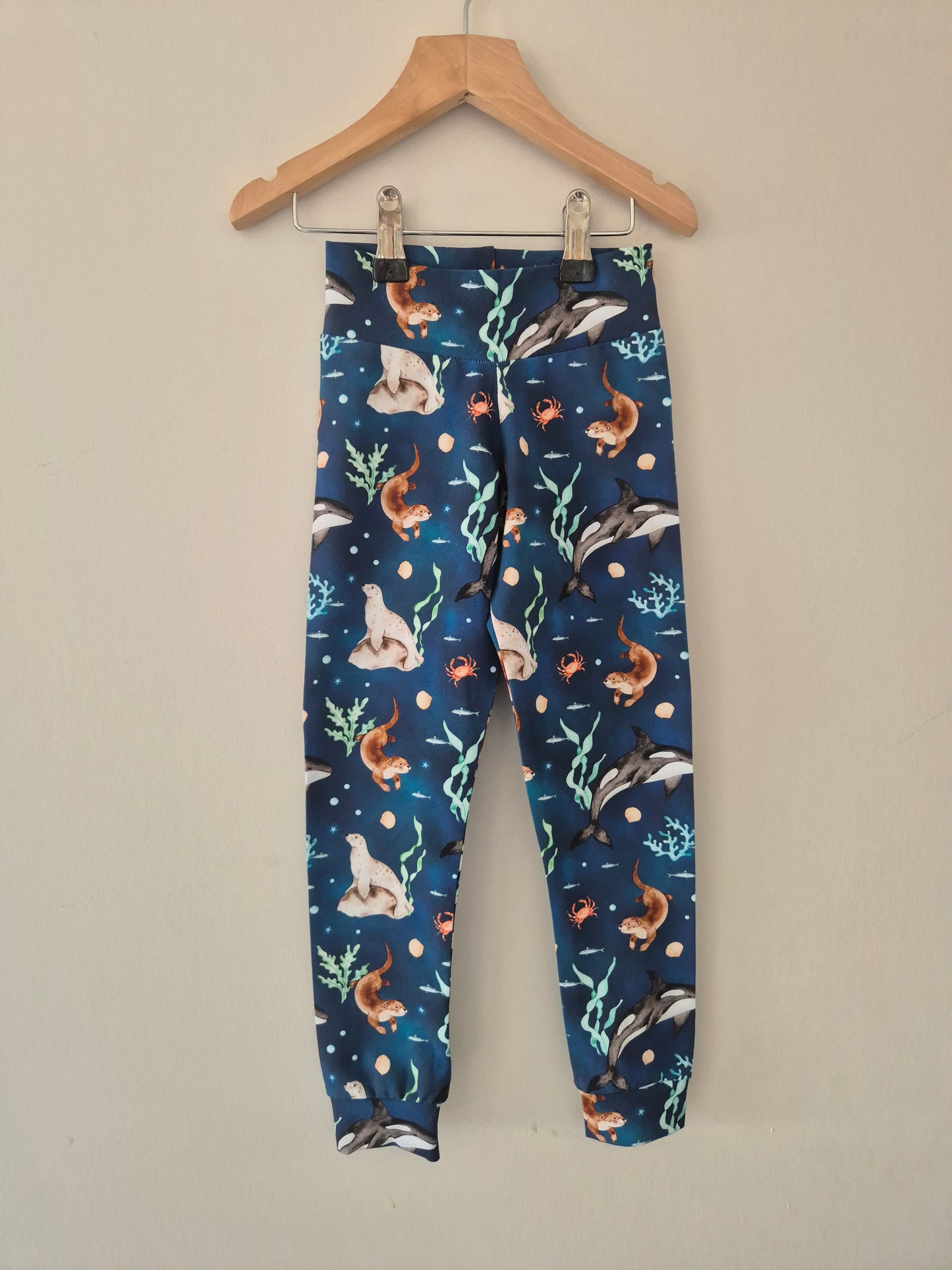 Children's leggings with sea creatures pattern on a hanger