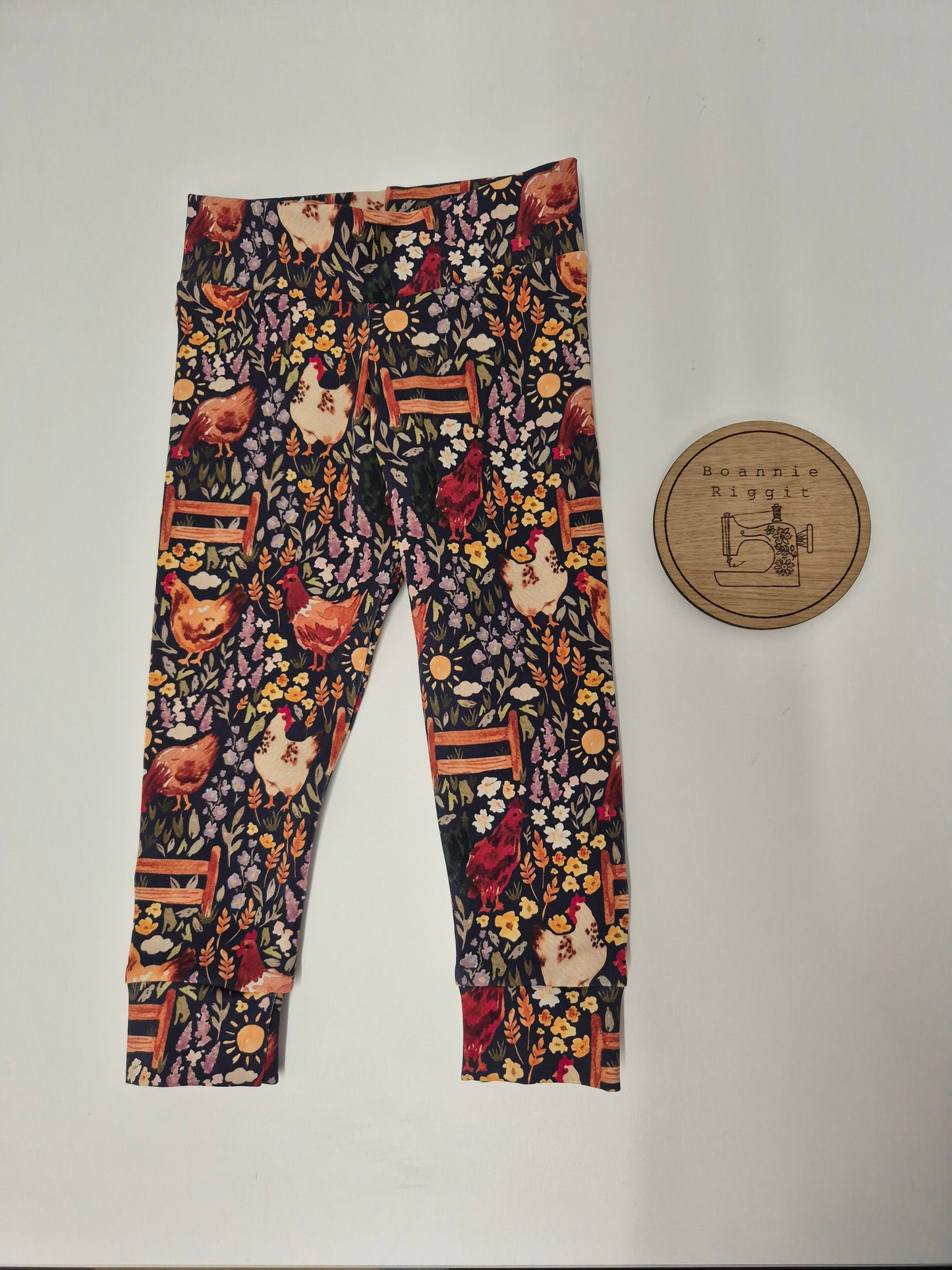 Leggings with floral and chicken pattern on a plain background