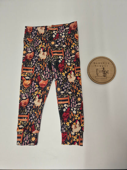 Leggings with floral and chicken pattern on a plain background