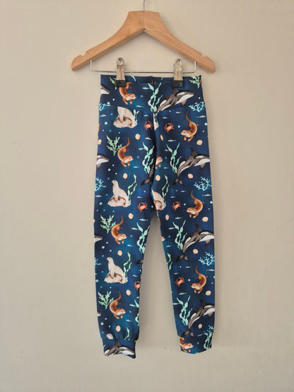 Children's leggings with sea creatures pattern on a hanger